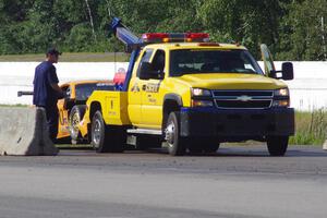 David Jans' Ford Mustang goes behind the wall after crashing at turn 13