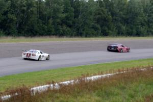 Amy Ruman's Chevy Corvette ahead of Cliff Ebben's Ford Mustang as the rain starts to fall again