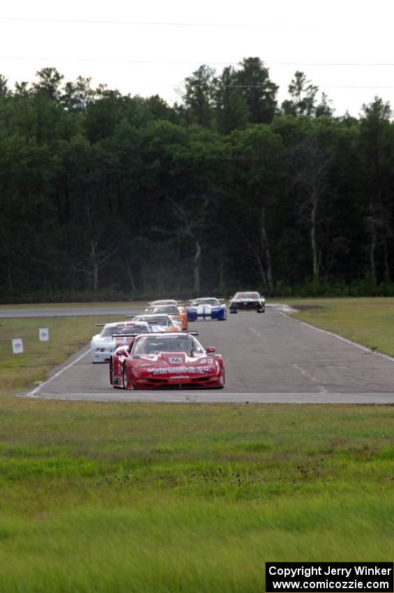 Amy Ruman's Chevy Corvette leads the field on lap two after Tony Ave spun at turn 12