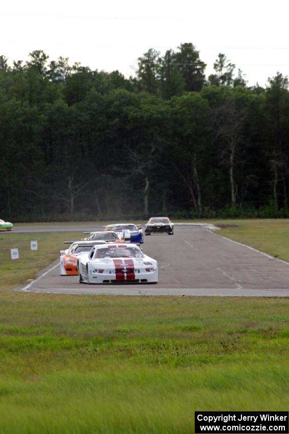 The field streams into corner 4 on the second lap