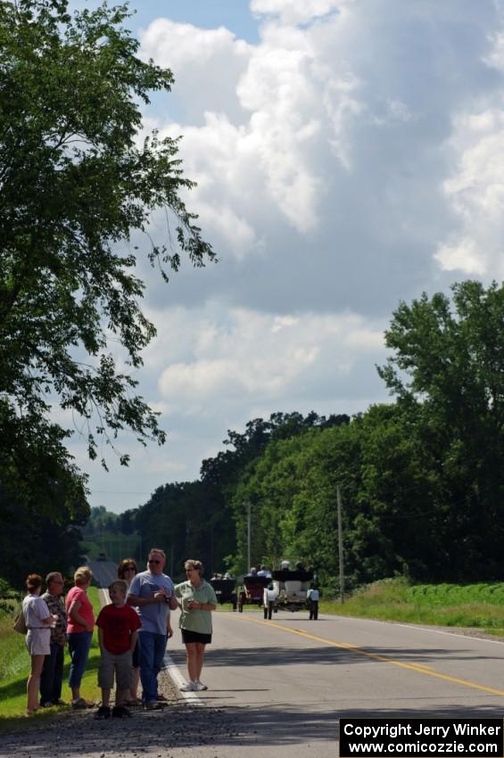 Nevy Clark's 1908 Buick putters away as spectators watch