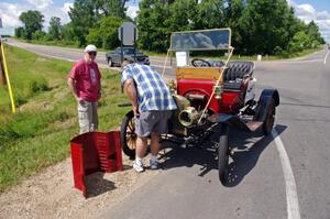 Doug Spacek's 1911 Maxwell gets repairs by the side of the road