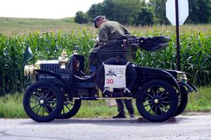 Richard Anderson's 1906 Maxwell has quick repairs done by the side of the road