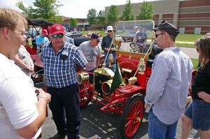 Tim Simonsma talks to passers-by about his 1911 Maxwell