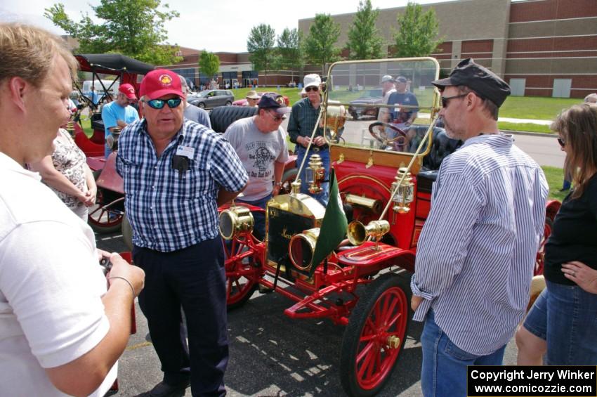 Tim Simonsma talks to passers-by about his 1911 Maxwell