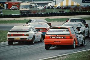 A gaggle of cars heads into turn 5