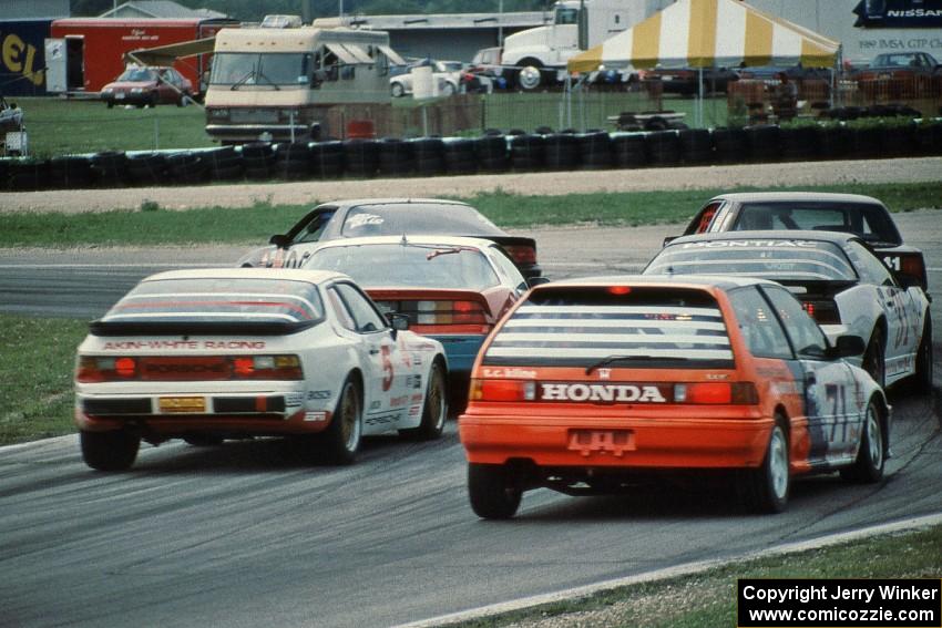 A gaggle of cars heads into turn 5