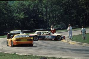 Bill Fuller's Buick Somerset (GTO) is stalled at turn one and the yellow flag slows the field