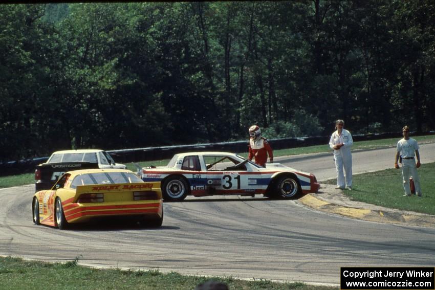 Bill Fuller's Buick Somerset (GTO) is stalled at turn one and the yellow flag slows the field