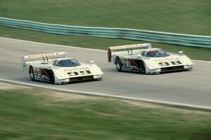 The Eagle Mk. III/Toyotas of Juan-Manuel Fangio II and P.J. Jones head uphill to turn 6 on the cool off lap