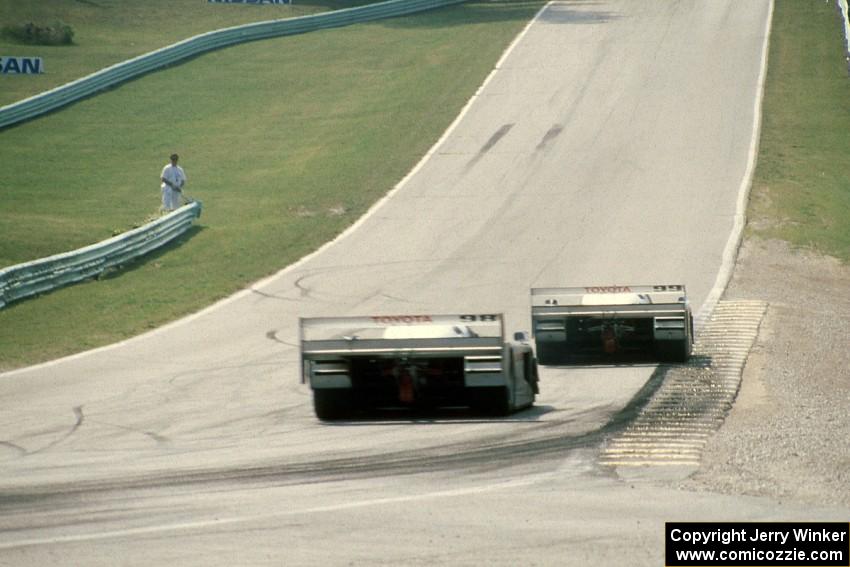 The Eagle Mk. III/Toyotas of P.J. Jones and Juan-Manuel Fangio II head uphill to corner 6