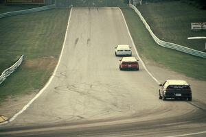 Three cars head out of turn 5 uphill toward 6