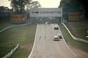 Four cars head out of turn 5 uphill toward 6