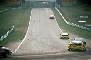 Five cars head out of turn 5 uphill toward 6