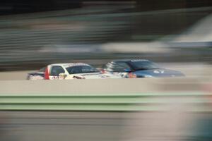 Dave Ahlheim / Terry Earwood Eagle Talon Turbo and Al Lepper / Gary Lippert Saturn SC go side-by-side down the front straight