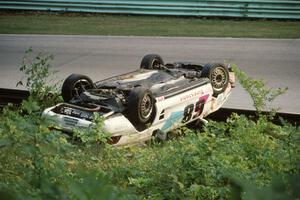 Peter Argetsinger's Toyota MR-2 Turbo jumped the outside turn 12 guardrail on lap 4 before landing upside down