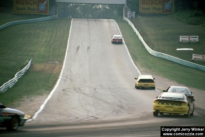 Five cars head out of turn 5 uphill toward 6