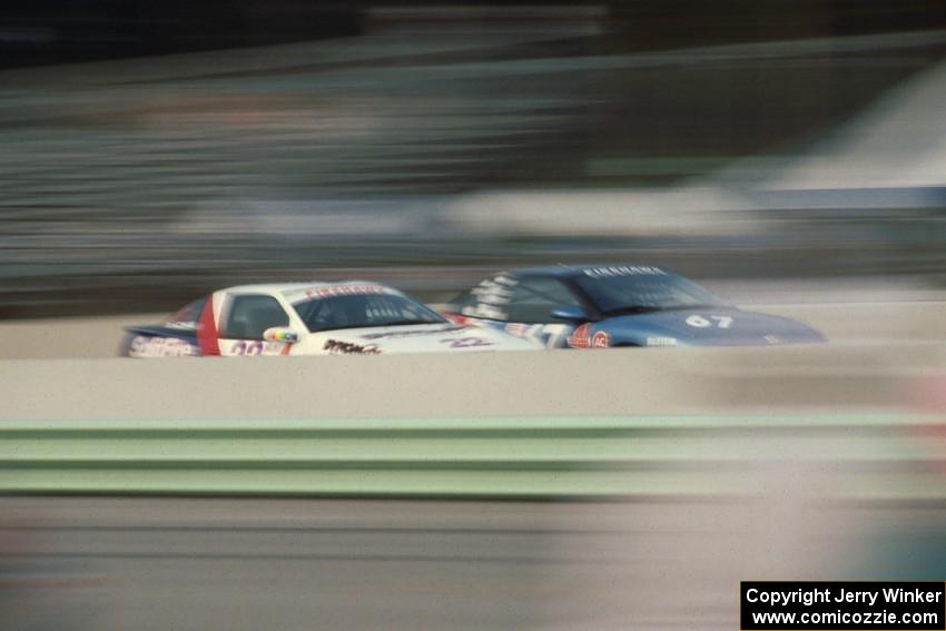 Dave Ahlheim / Terry Earwood Eagle Talon Turbo and Al Lepper / Gary Lippert Saturn SC go side-by-side down the front straight