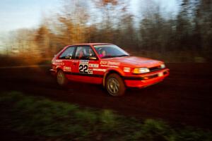 Gail Truess / Pattie Hughes Mazda 323GTX at speed on the practice stage.