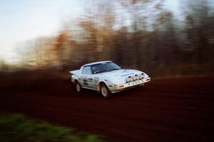 Ted Grzelak / Chris Plante Mazda RX-7 at speed on the practice stage.