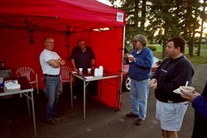 Denny Orr and Jon Davis chat with Randy Jokela and Brad Folino who have just gotten bowls of chili at Kenton service.