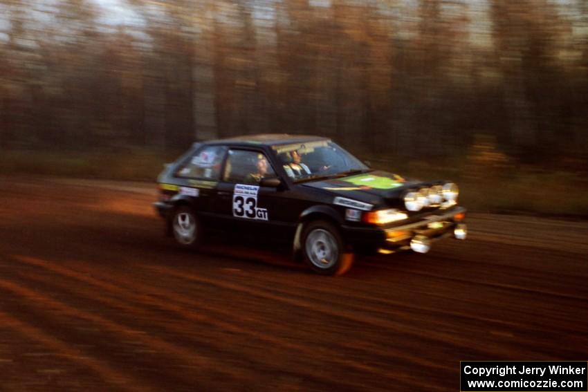 Tom Ottey / Pam McGarvey Mazda 323GTX at speed on the practice stage.