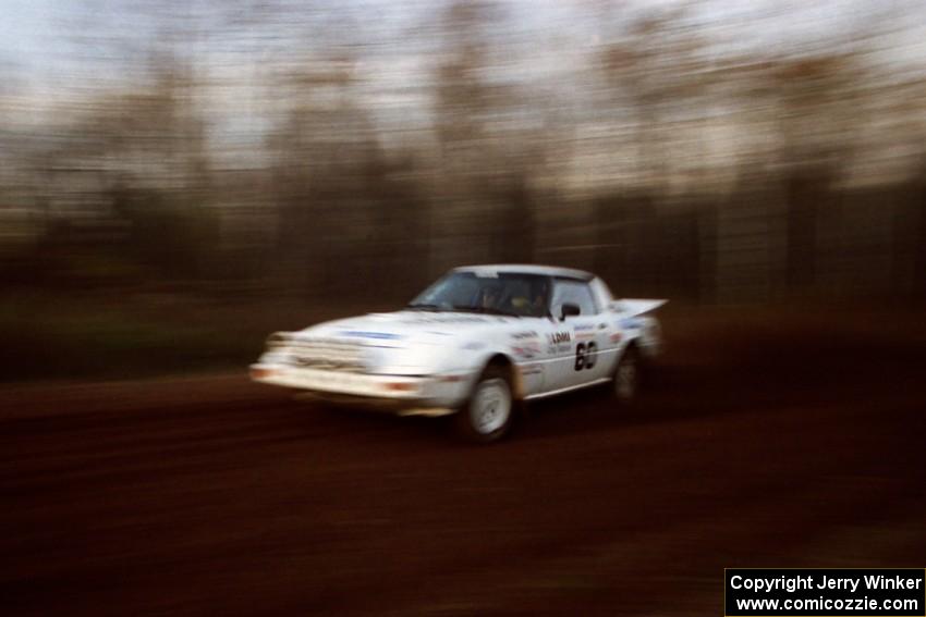 Ted Grzelak / Chris Plante Mazda RX-7 at speed on the practice stage.