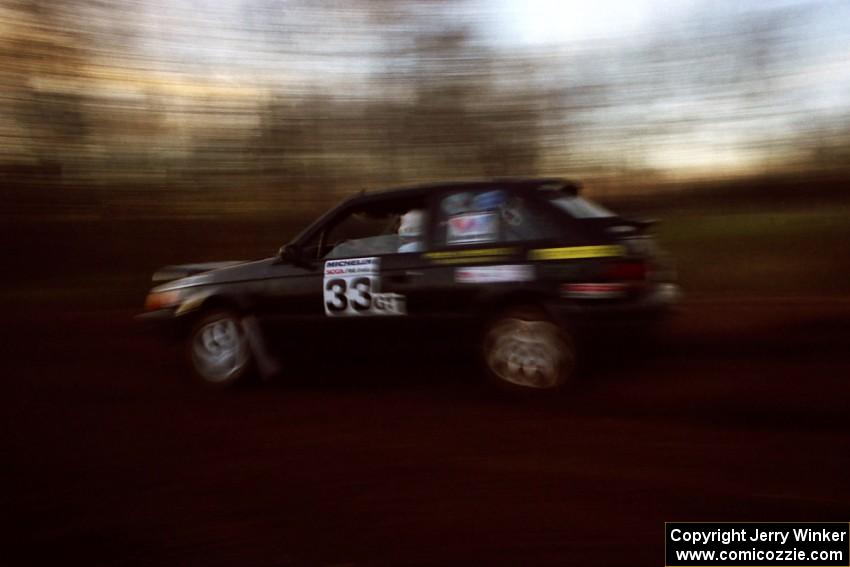 Tom Ottey / Pam McGarvey Mazda 323GTX at speed on the practice stage.