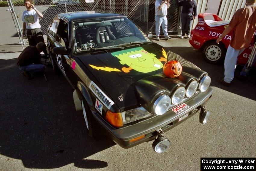 Tom Ottey / Pam McGarvey Mazda 323GTX at parc expose outside Dee Stadium.