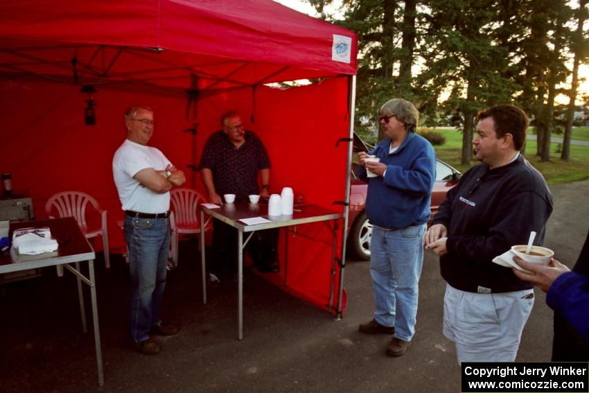 Denny Orr and Jon Davis chat with Randy Jokela and Brad Folino who have just gotten bowls of chili at Kenton service.