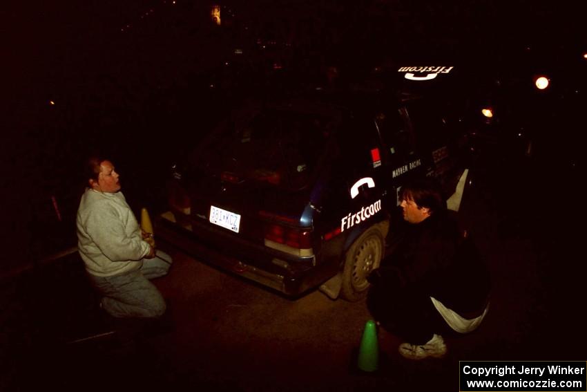 Mary Utecht and Jim Konkler work on the Mark Utecht / Brenda Corneliusen Dodge Omni GLH-Turbo at the third Kenton service.