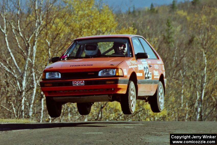 Gail Truess / Pattie Hughes Mazda 323GTX catches air on SS13, Brockway I.