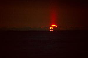 The sunset over Lake Michigan created a beam of light that went upward.