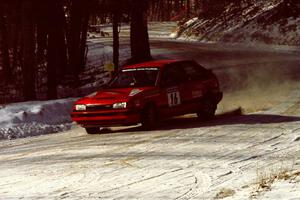 Gail Truess / Pattie Hughes come into the SS1 spectator area in their Mazda 323GTX.