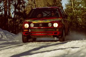 Karl Scheible / Gail McGuire speed over a blind crest in their VW GTI before sunset.