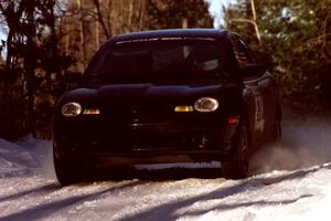 Evan Moen / Ron Moen Plymouth Neon ACR at speed over a blind crest before sunset.