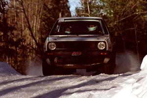 Wayne Prochaska / Annette Prochaska at speed over a crest before sundown in their VW Golf.