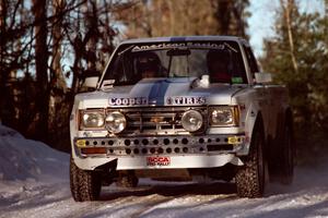 Ken Stewart / Jim Dale Chevy S-10 at speed over a crest before sunset.