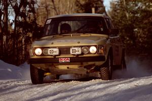 Tim Winker / Brenda Corneliusen come over a crest at speed in their SAAB 99 before sundown.