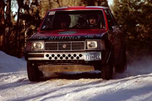 Jim Buchwitz / C.O. Rudstrom come over a crest at speed in their Mercury Lynx just before sundown.