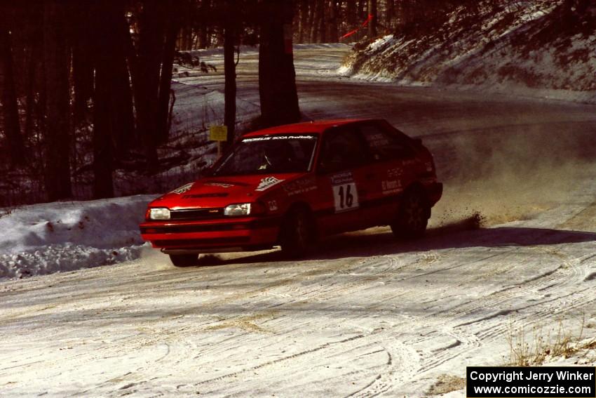 Gail Truess / Pattie Hughes come into the SS1 spectator area in their Mazda 323GTX.