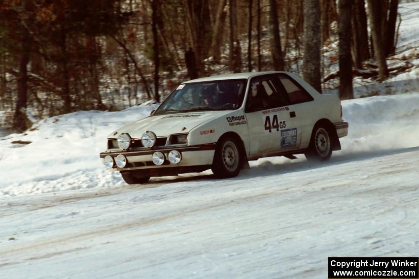 Henry Krolikowski / Cindy Krolikowski set up their Dodge Shadow for a 90-left at the SS1 spectator corner.