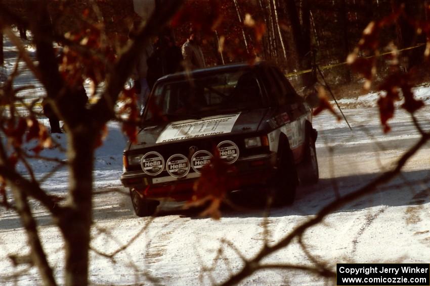 Eric Schroeder / Jeff Secor VW Jetta drifts wide at a slippery left-hander at the SS1 spectator location.