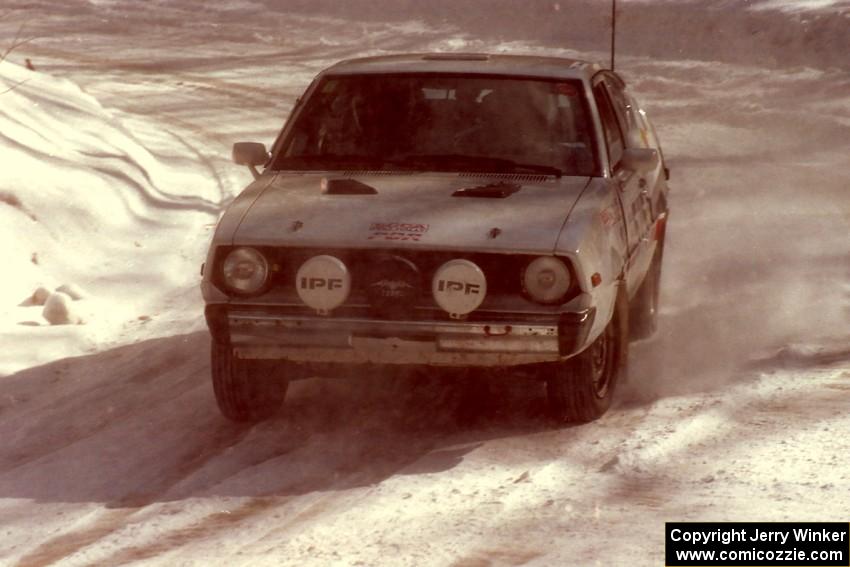 Jeremy Butts / Peter Jacobs Plymouth Arrow drives through snow dust at a right-hander on SS3.