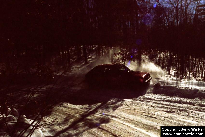 Jon Butts / Gary Butts drift wide and clip the outside bank in their Dodge Omni.