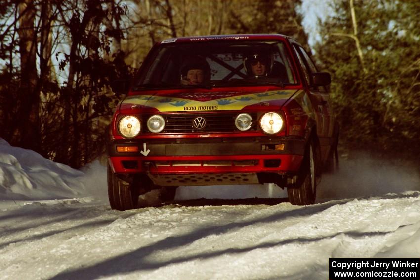 Karl Scheible / Gail McGuire speed over a blind crest in their VW GTI before sunset.