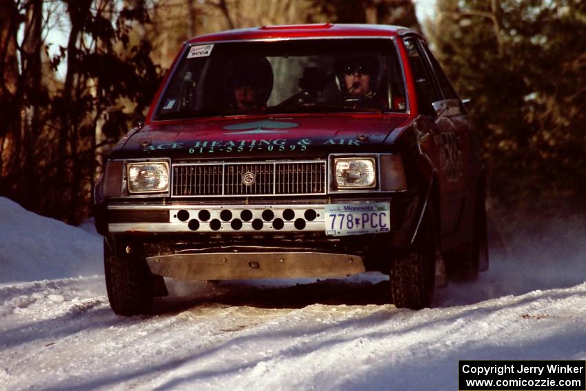 Jim Buchwitz / C.O. Rudstrom come over a crest at speed in their Mercury Lynx just before sundown.