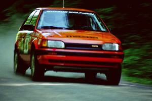 Gail Truess / Pattie Hughes Mazda 323GTX at speed on the practice stage.