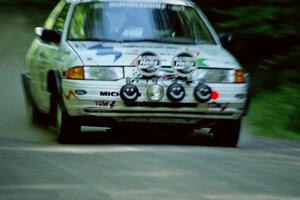 Charlie Langan / Hughie Langan Ford Escort GT at speed on the practice stage.