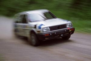 Eric Burmeister / Mark Buskirk VW GTI at speed on the practice stage.